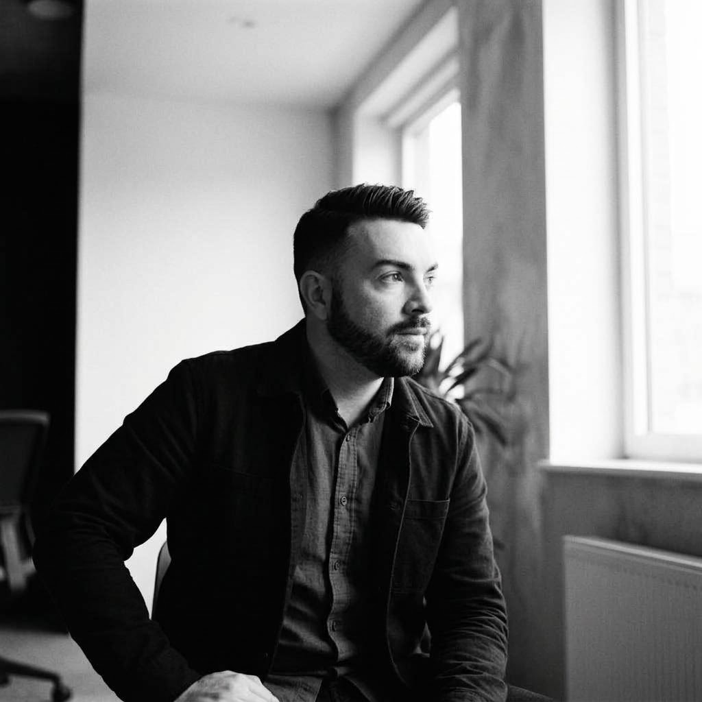 AI styled editorial portrait of John P. Cronin seated beside an office window
